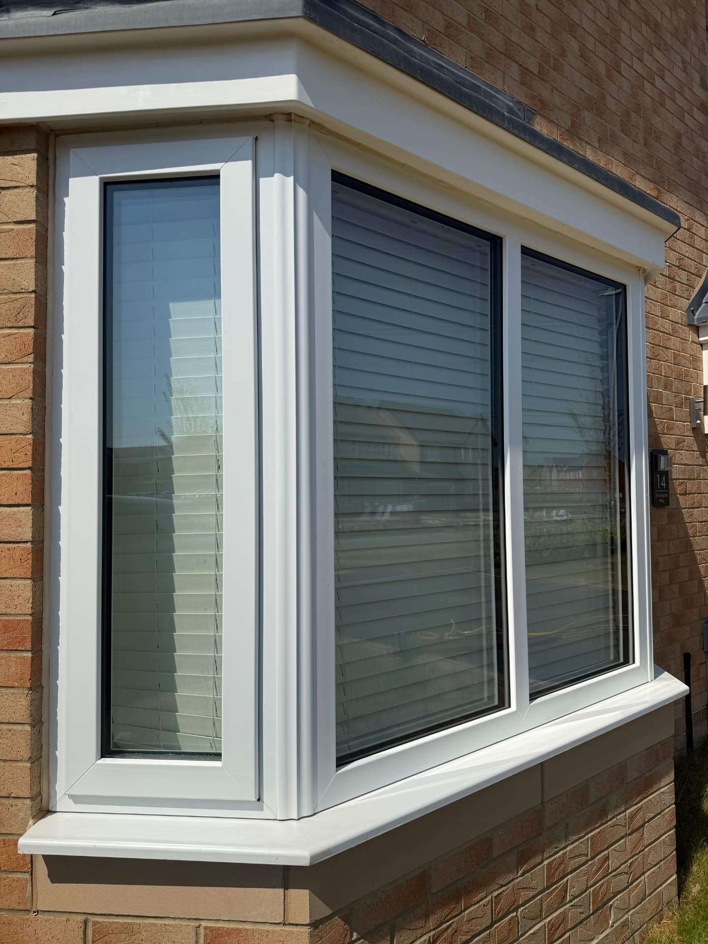 Freshly cleaned white uPVC bay window with spotless glass and sills